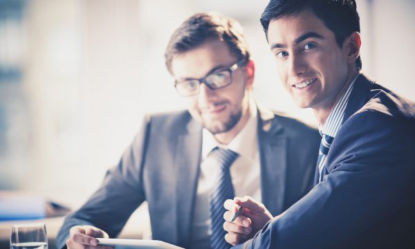 Businessmen at meeting Image of smart young businessmen looking at camera at meeting